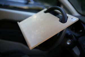 Notebook Wheeldesk car desk mounted on a car steering wheel.